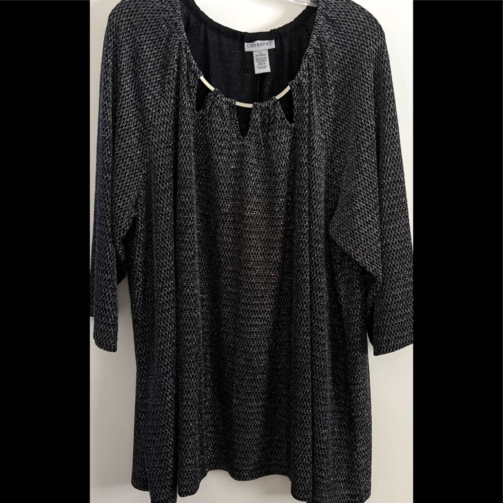 Metalic, blk/silver beauty. Designer neckline. In brand new cond. Quality piece